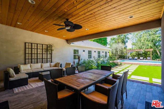 a outdoor dining space with furniture and wooden floor