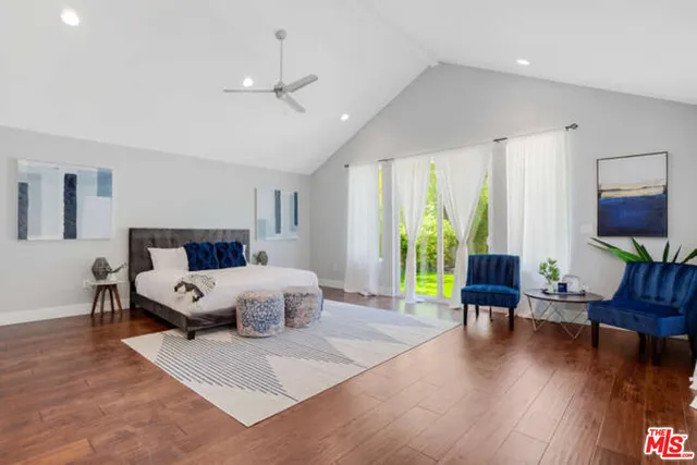 a bedroom with furniture and wooden floor