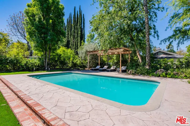 a view of swimming pool with lounge chair