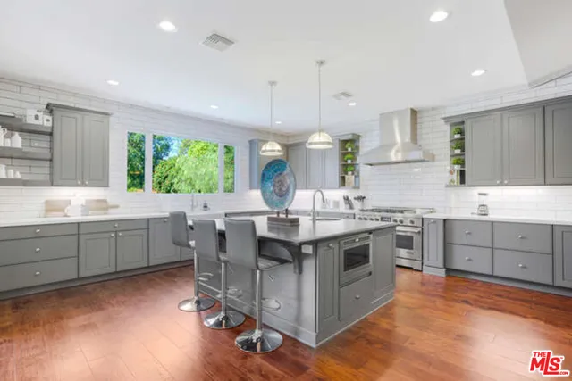 a kitchen with a sink stove and wooden cabinets