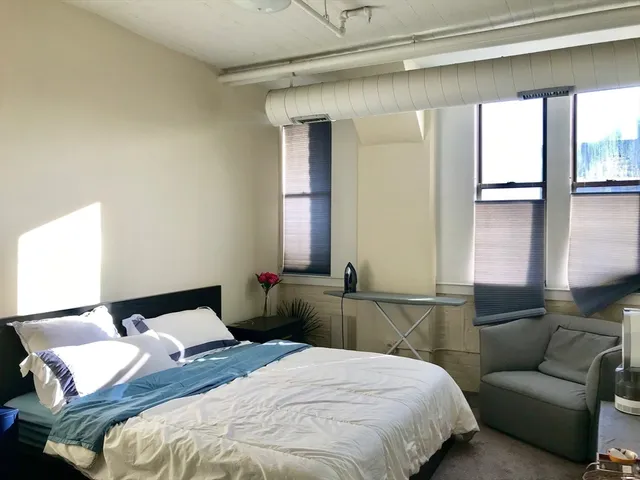 a bedroom with a bed and a couch