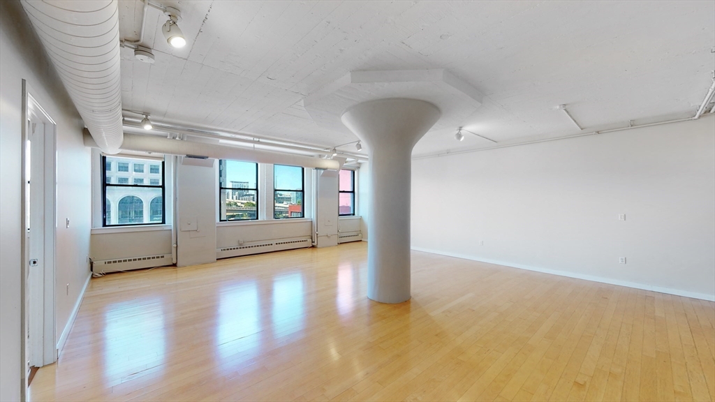 210 South Street, Unit 104 Boston, MA 02111 - Photo 7 of 24 a view of an empty room with a window