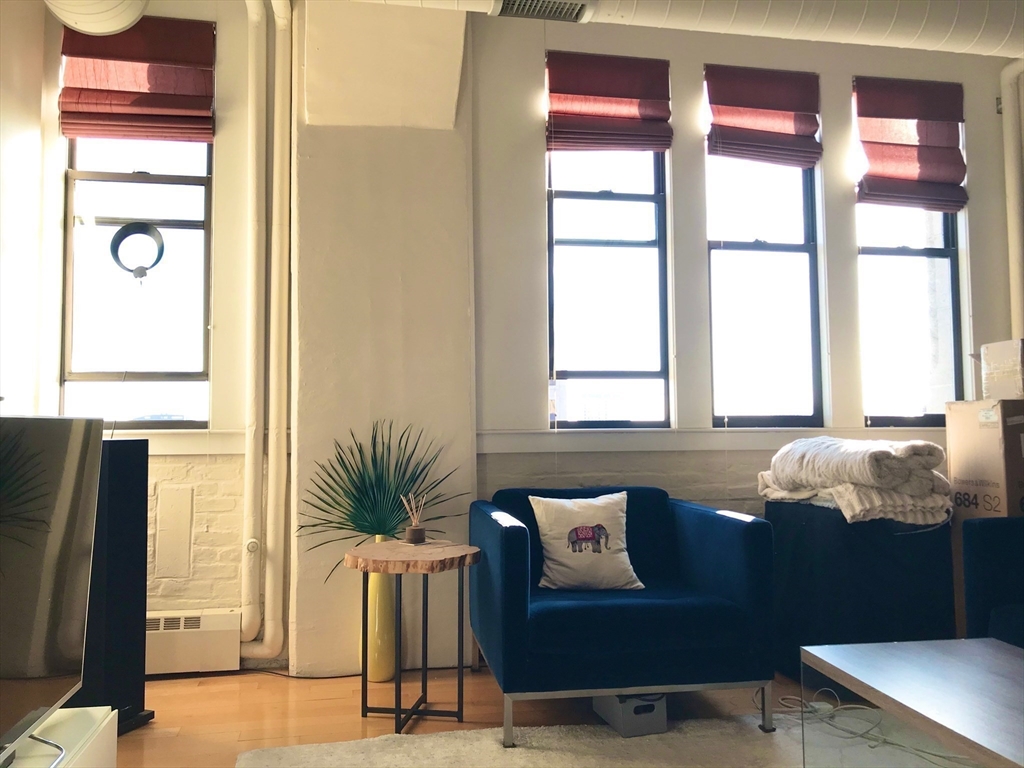 210 South Street, Unit 104 Boston, MA 02111 - Photo 10 of 24 a living room with furniture and large window