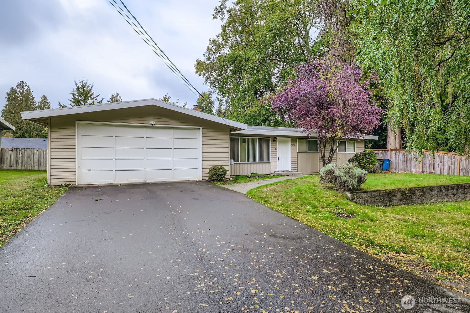 5031 158th Street Southwest Edmonds, WA 98026 - Photo 1 of 17 a front view of a house with a yard and garage