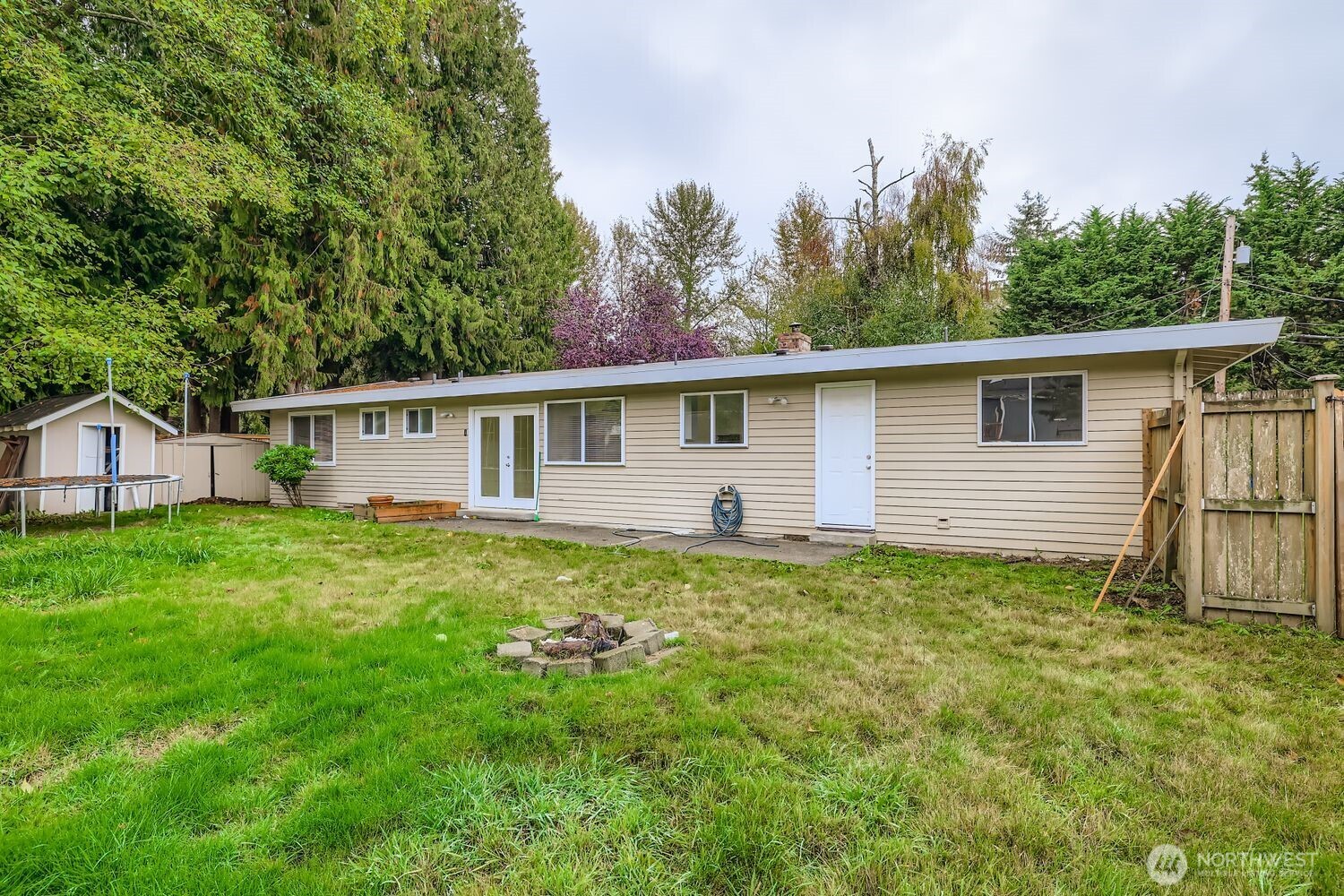 5031 158th Street Southwest Edmonds, WA 98026 - Photo 17 of 17 a view of a backyard with plants and a garden