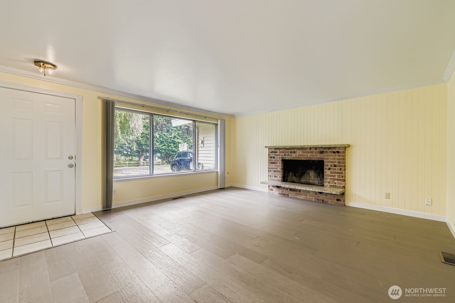 5031 158th Street Southwest Edmonds, WA 98026 - Photo 4 of 17 an empty room with floor to ceiling window and fireplace