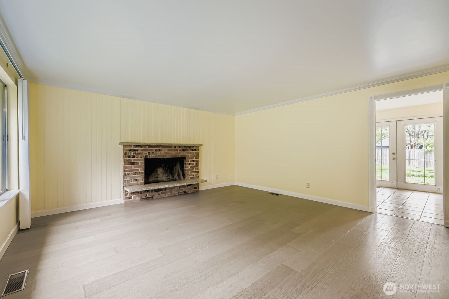 5031 158th Street Southwest Edmonds, WA 98026 - Photo 5 of 17 an empty room with wooden floor and a fireplace