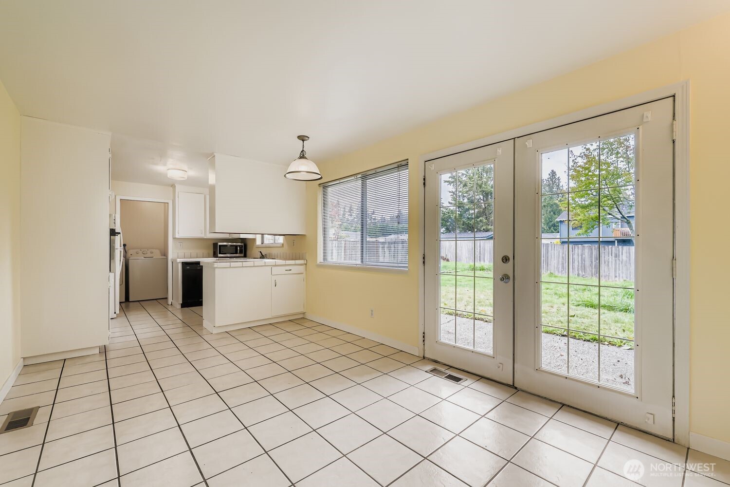 5031 158th Street Southwest Edmonds, WA 98026 - Photo 6 of 17 a large white kitchen with white cabinets and refrigerator