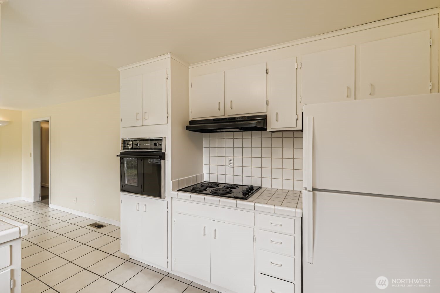 5031 158th Street Southwest Edmonds, WA 98026 - Photo 8 of 17 a kitchen with white cabinets and stainless steel appliances