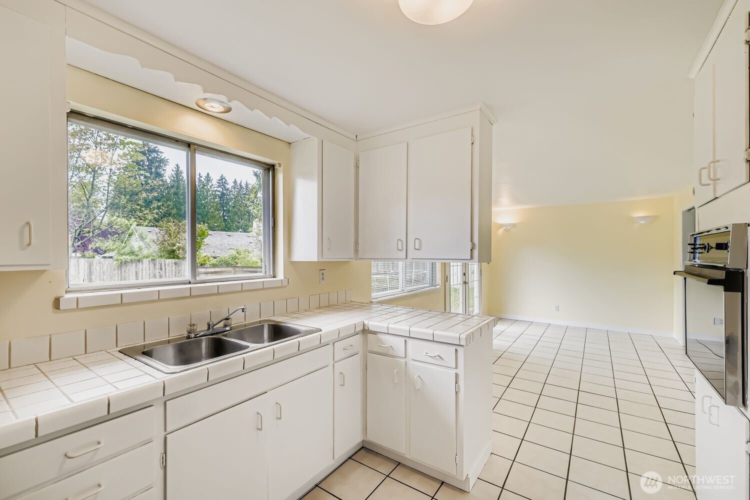 5031 158th Street Southwest Edmonds, WA 98026 - Photo 9 of 17 a kitchen with a sink cabinets and window