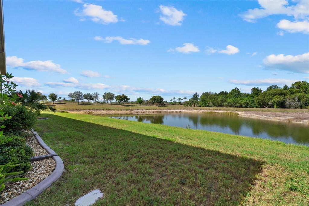 20080 Ragazza Circle, Unit 102 Venice, FL 34293 - Photo 33 of 49 a view of a lake with houses in the back