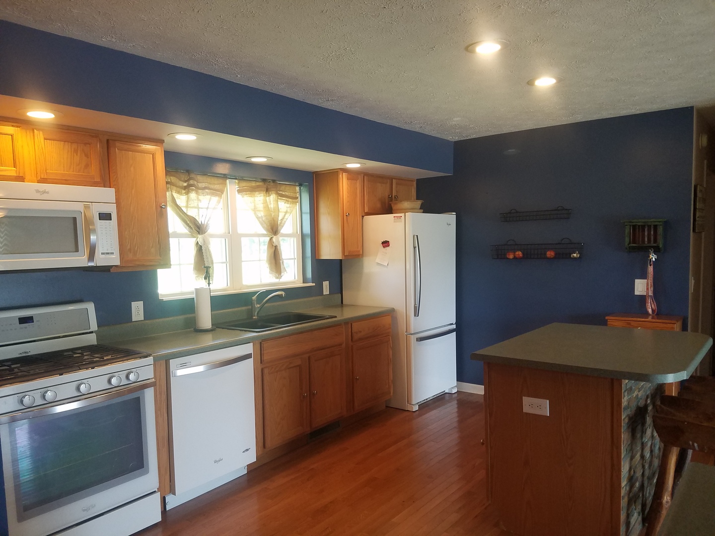 25814 Mary Road Garden Prairie, IL 61038 - Photo 3 of 19 a kitchen with stainless steel appliances granite countertop a refrigerator a sink dishwasher a stove and a dining table with wooden floor