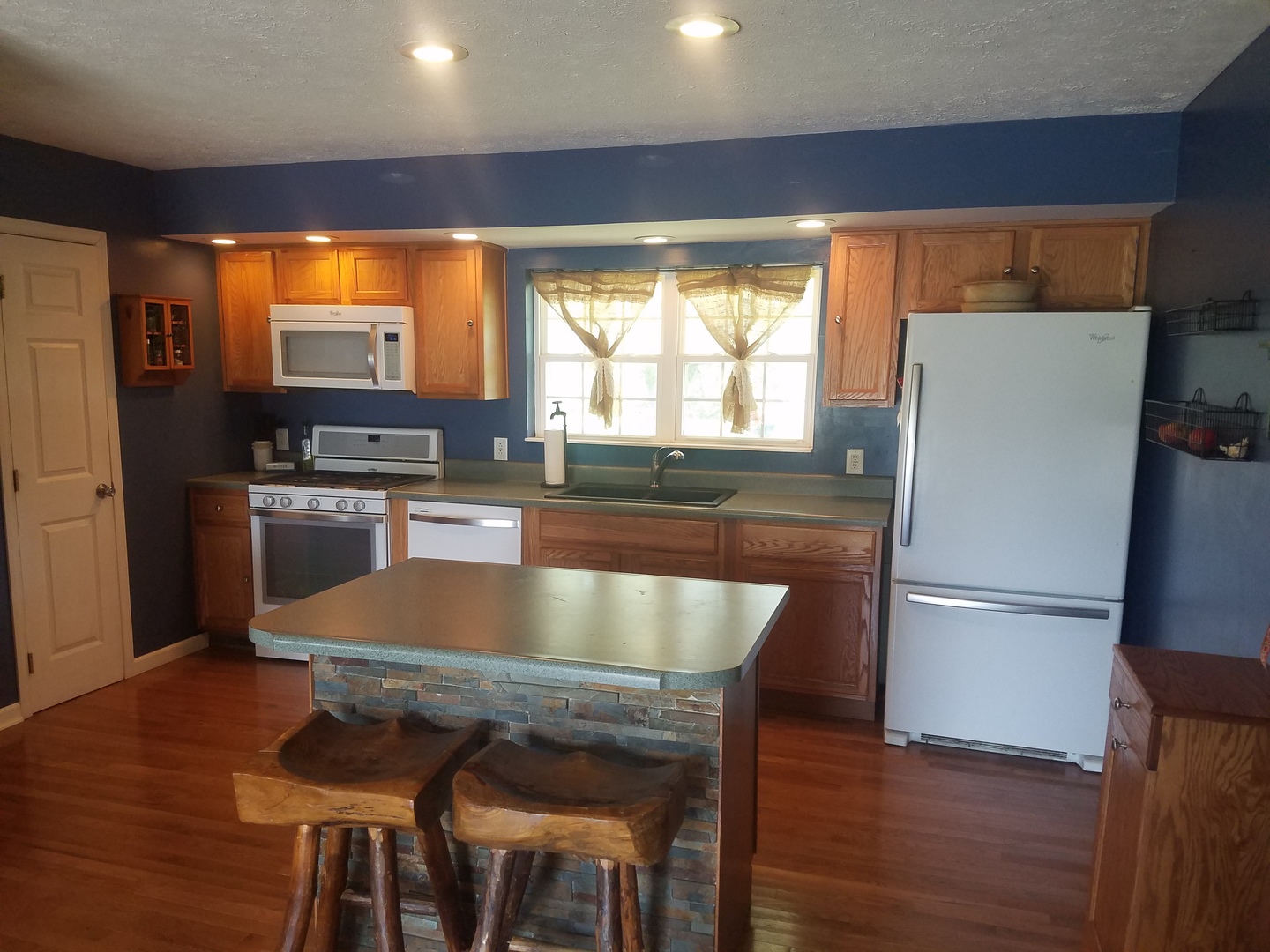 25814 Mary Road Garden Prairie, IL 61038 - Photo 4 of 19 a kitchen with granite countertop a refrigerator and wooden floor