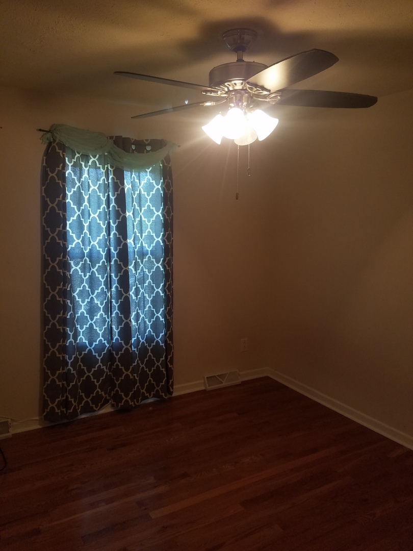 25814 Mary Road Garden Prairie, IL 61038 - Photo 10 of 19 a view of empty room with wooden floor and fan