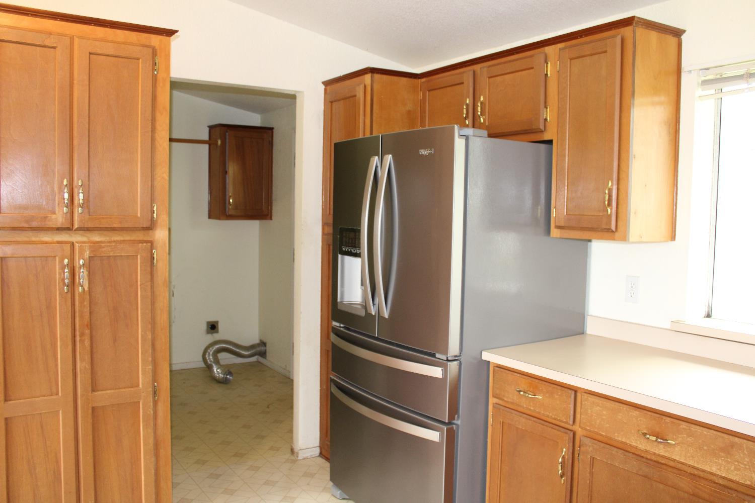 12245 Hobday Road Wilton, CA 95693 - Photo 13 of 16 Kitchen, showing the refrigerator and Laundry/mud room