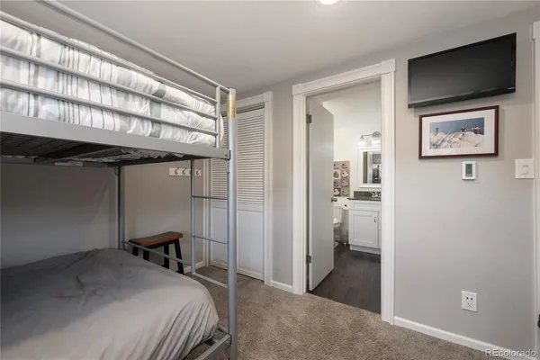 a bedroom with a bed and a view of bathroom