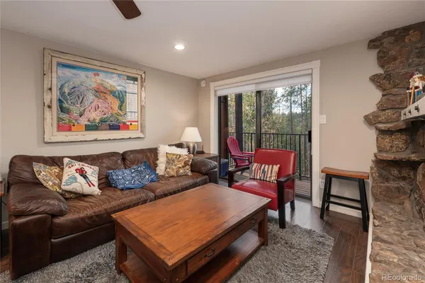 a living room with furniture a rug and a large window