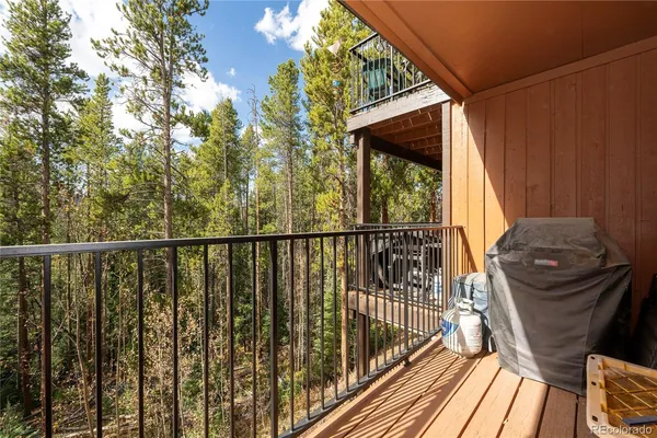 a view of balcony with wooden floor and outdoor seating