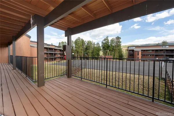 a view of a balcony with wooden floor