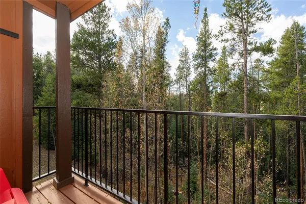 a balcony with trees in front of it