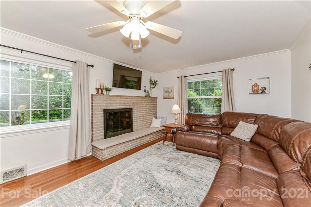 5662 Pagemont Road Kannapolis, NC 28081 - Photo 3 of 27 a living room with furniture a flat screen tv and a fireplace