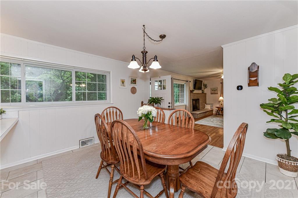 5662 Pagemont Road Kannapolis, NC 28081 - Photo 7 of 27 a dining room with furniture potted plants and wooden floor