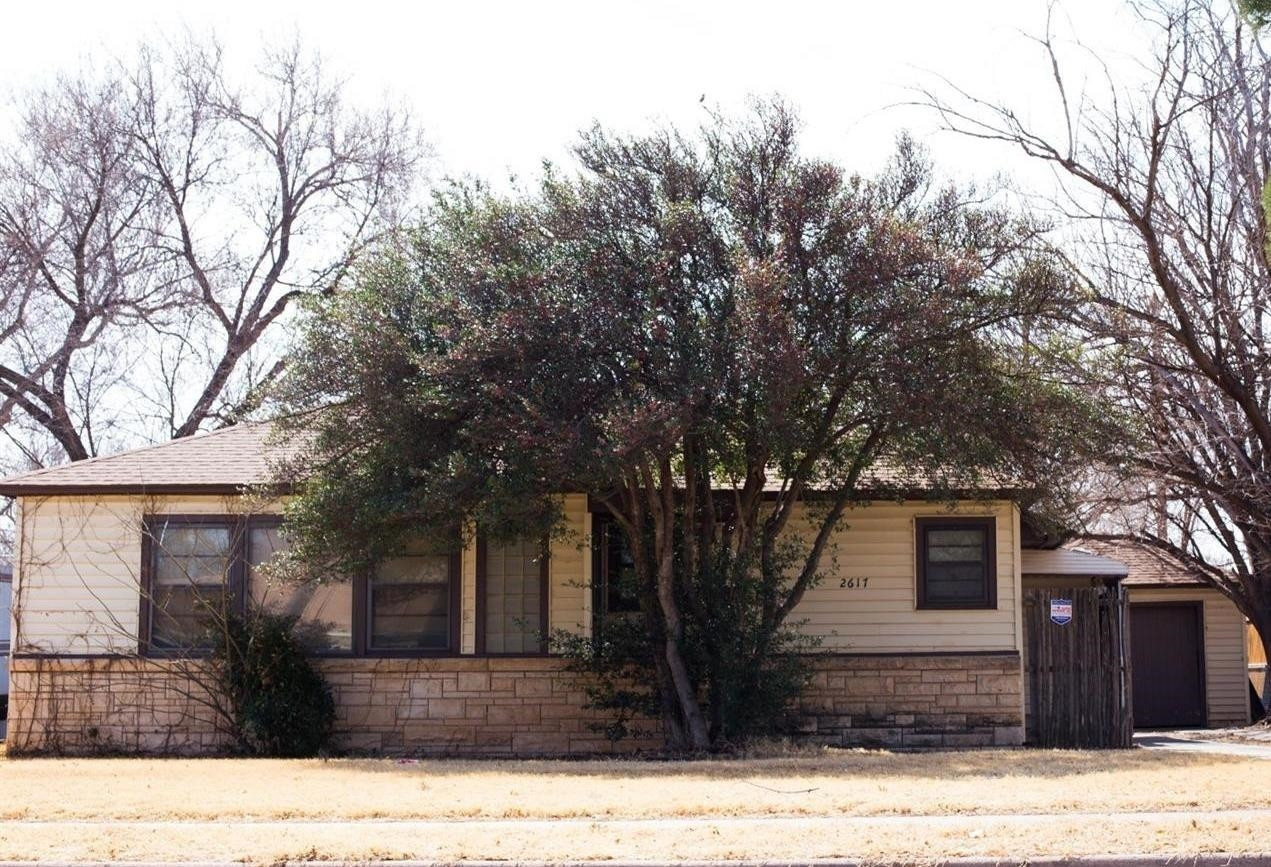 2617 37th Street Lubbock, TX 79413 - Photo 1 of 10 a front view of a house with a yard
