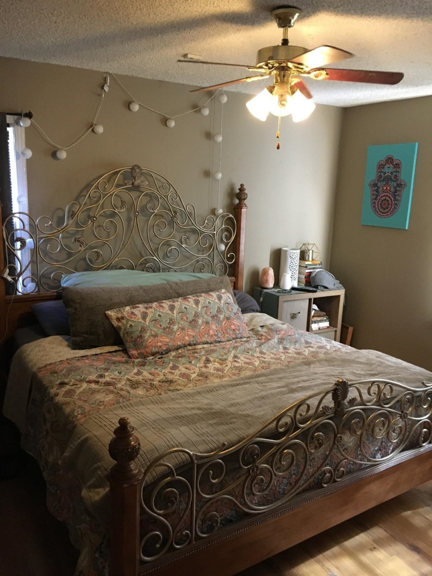 2617 37th Street Lubbock, TX 79413 - Photo 5 of 10 a bedroom with a bed and a chandelier