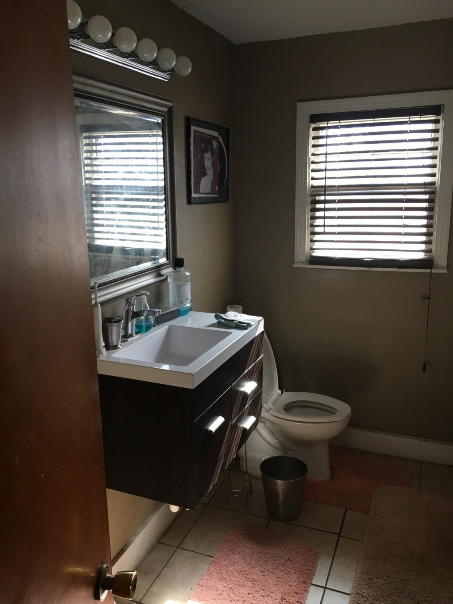 2617 37th Street Lubbock, TX 79413 - Photo 6 of 10 a bathroom with a sink a toilet and a window