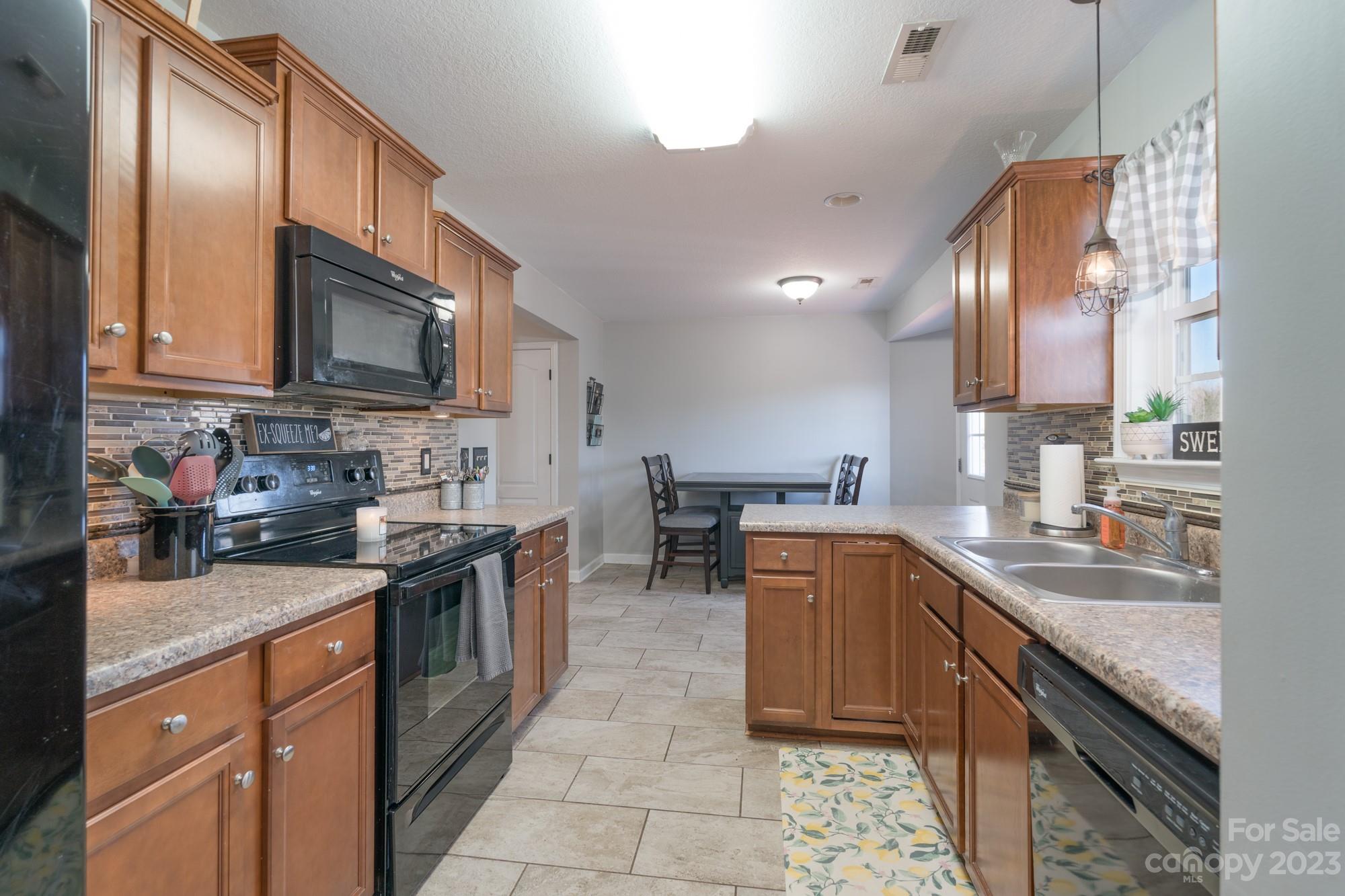 257 Springlake Road York, SC 29745 - Photo 8 of 28 a kitchen with a sink stove top oven and cabinets