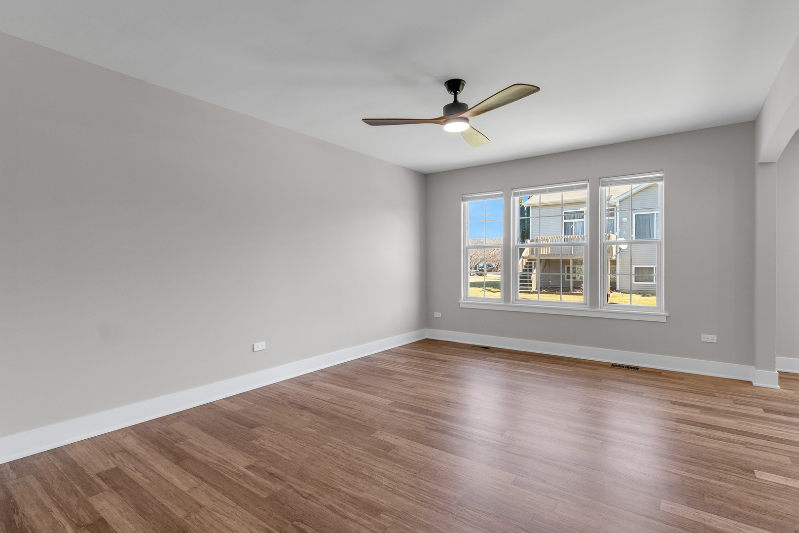 25653 Bridle Path Channahon, IL 60410 - Photo 10 of 43 an empty room with wooden floor windows and ceiling fan