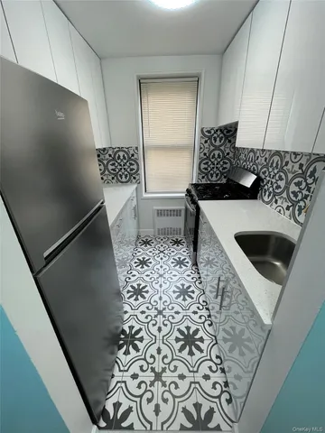 a kitchen with a sink and a refrigerator