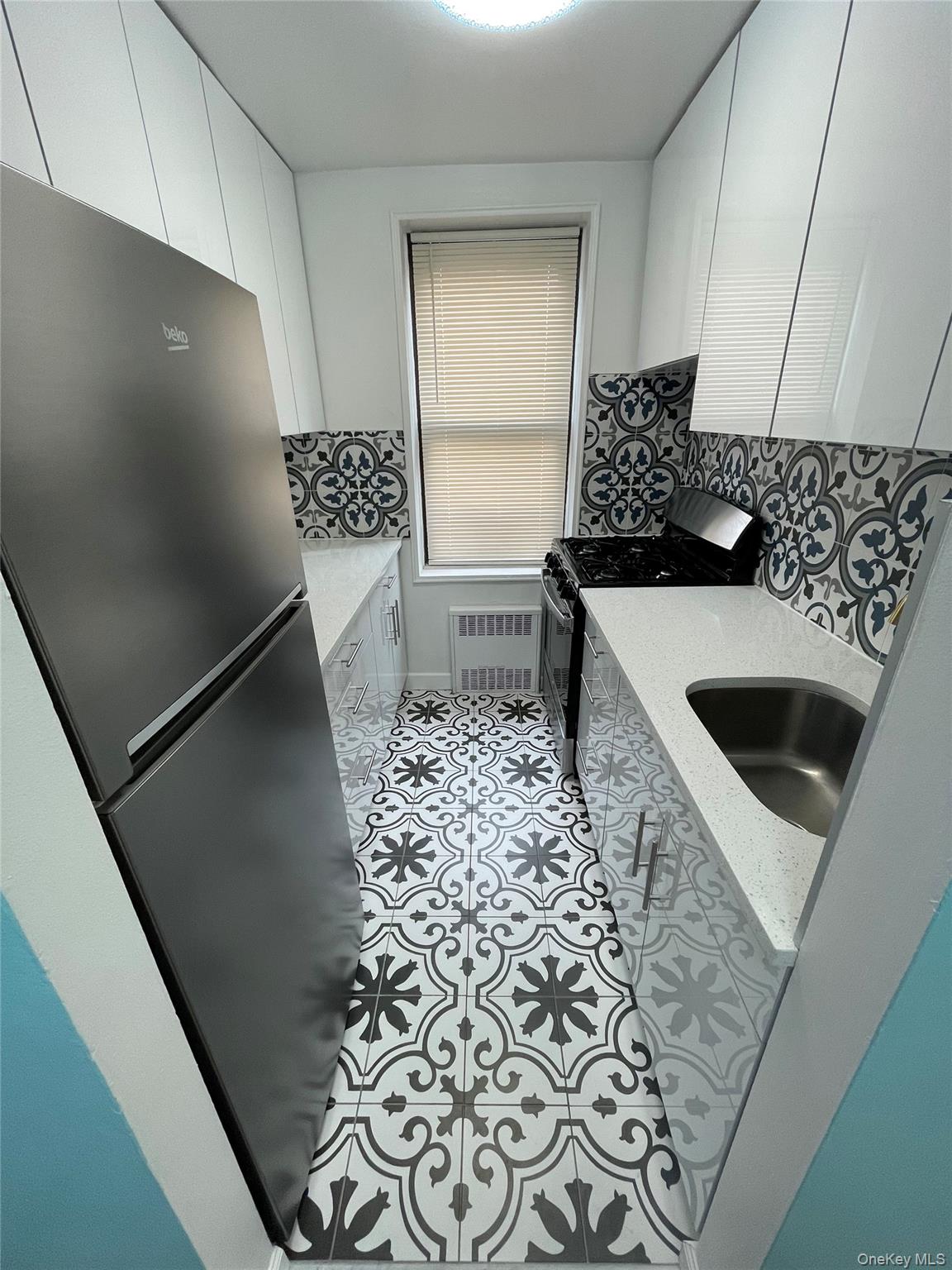 a kitchen with a sink and a refrigerator