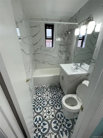 a bathroom with a toilet a sink and a bathtub
