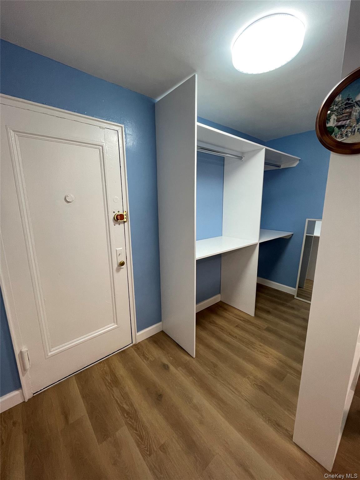 83-85 116th Street, Unit 3F Queens, NY 11418 - Photo 3 of 5 an empty room with wooden floor and windows