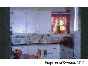 4242 Rt 307 Moscow, PA 18444 - Photo 4 of 5 a kitchen with a sink and cabinets