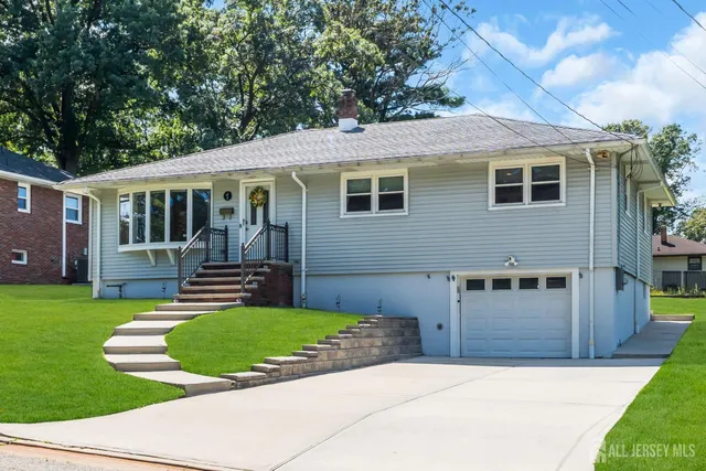 a view of a house with a backyard