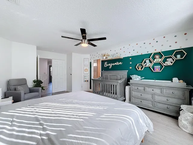 a bedroom with a bed and a potted plant