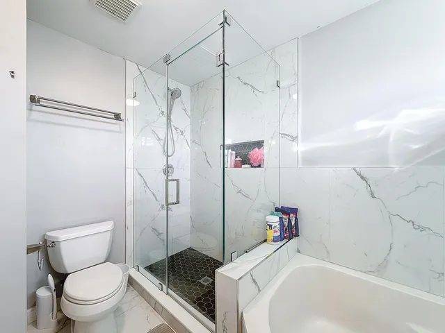 a view of a backyard with a garden and entertaining space