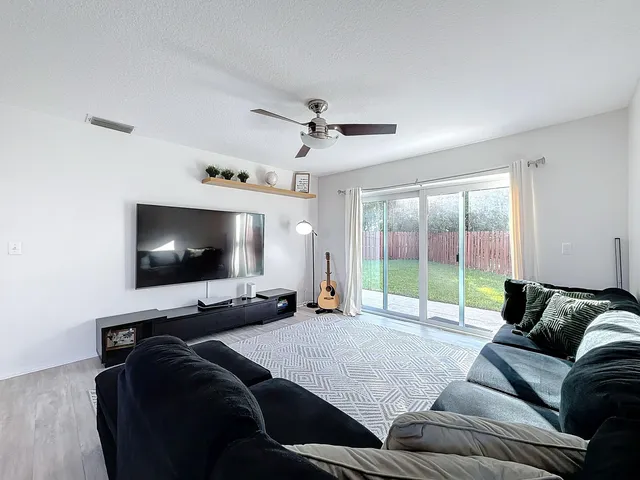 a view of empty room with wooden floor and windows