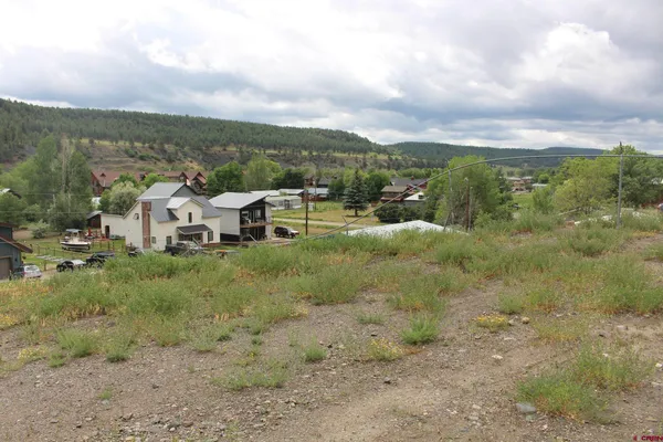 a view of a town with trees in the background