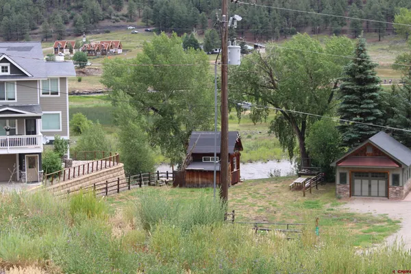 a view of house with a yard