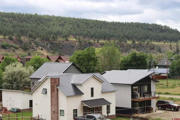 an aerial view of a house with a yard