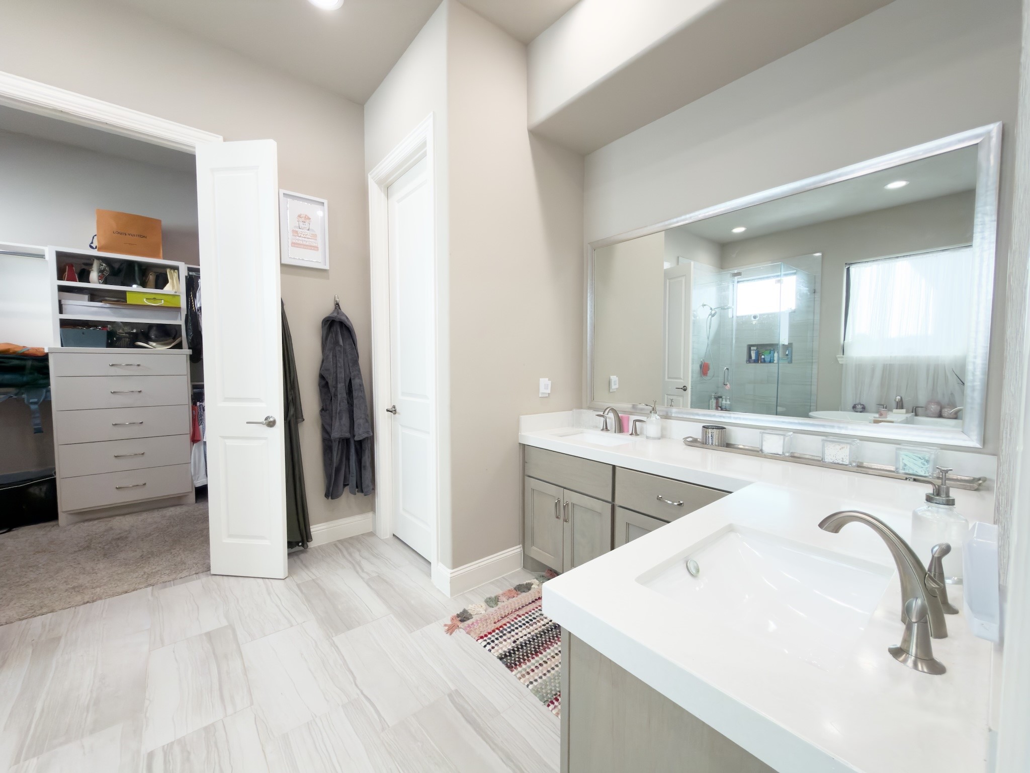 2437 Prairie Hollow Lane Houston, TX 77077 - Photo 17 of 27 a bathroom with a sink a toilet a mirror and vanity