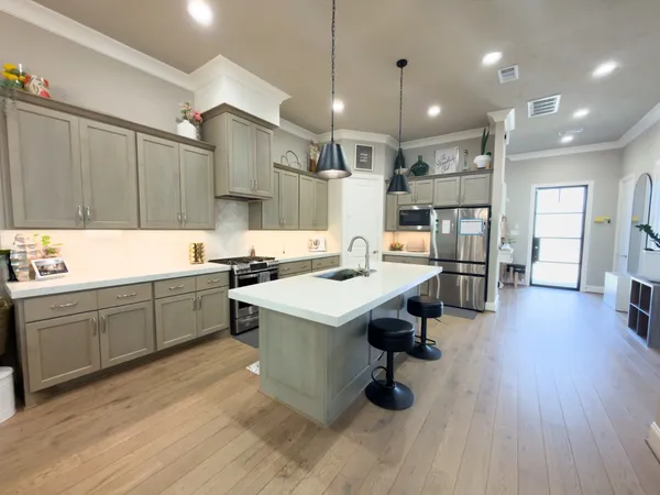a kitchen with a sink appliances and cabinets