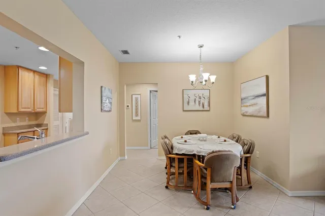 a view of a dining room with furniture and chandelier