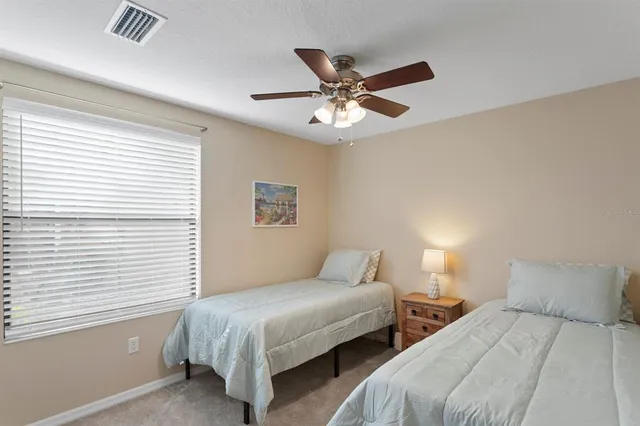 a bedroom with two beds and a window