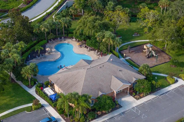 an aerial view of a house with garden space and street view