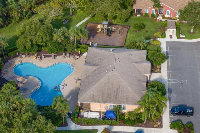 an aerial view of a house with yard swimming pool and outdoor seating