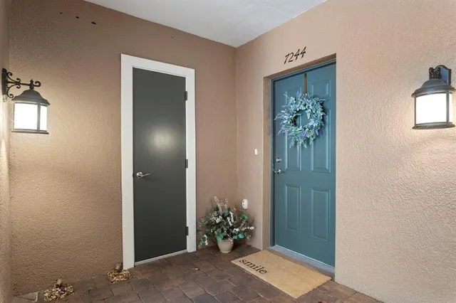a view of a hallway with wooden shelves